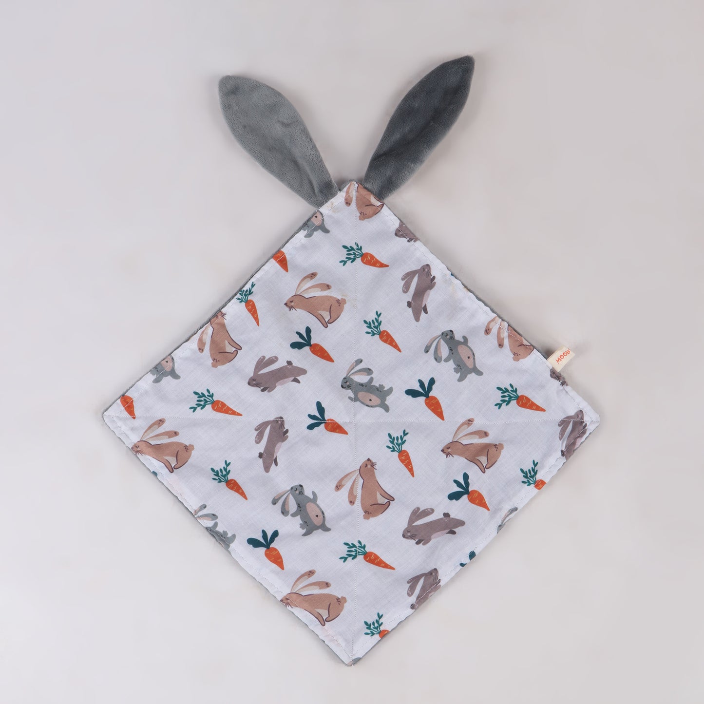 Close up of soft security blanket with comforting textures with bunny and carrot print and bunny ears showing its full size which is perfect for soothing babies and toddlers