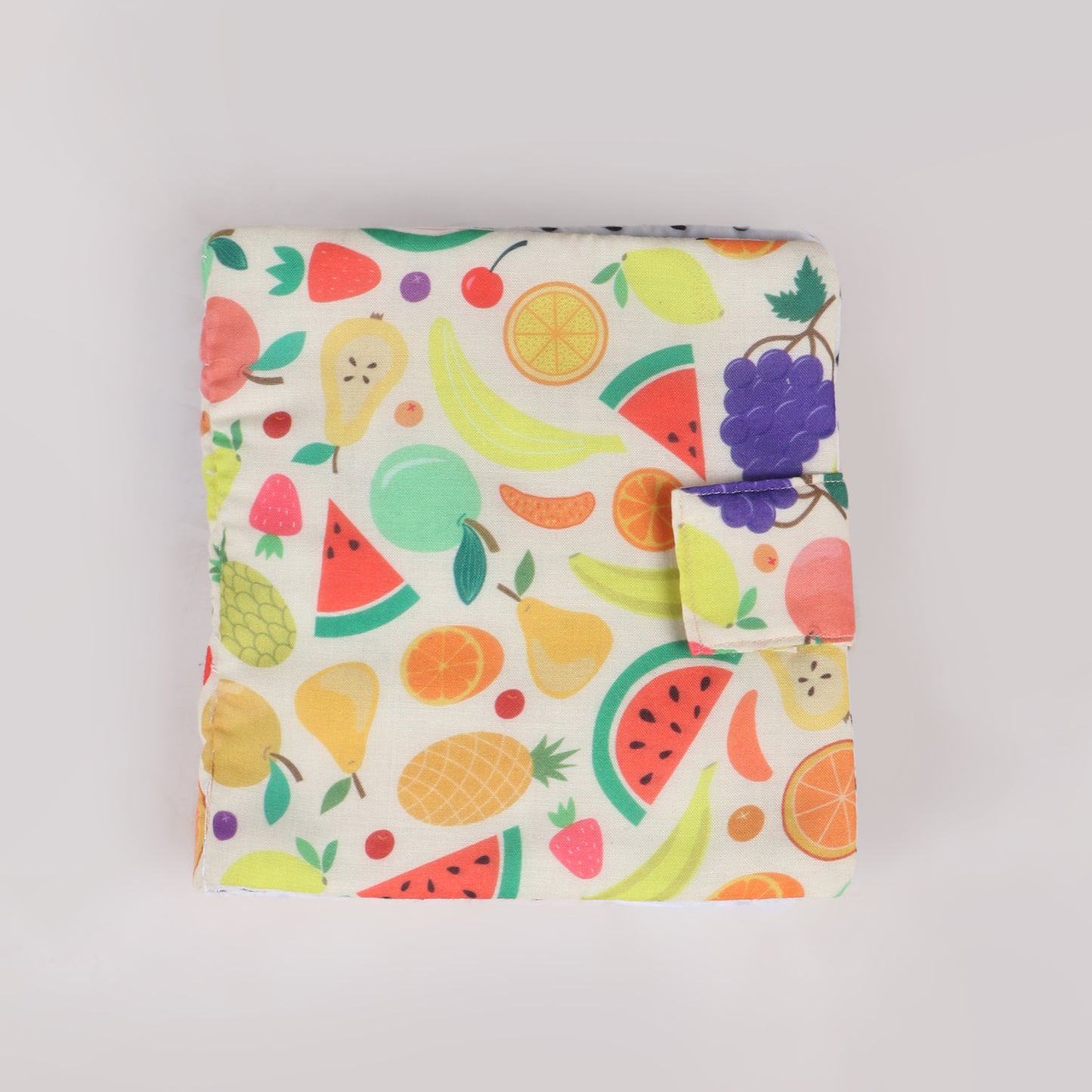 Fruit-themed busy book with fruit printed fabric and has interactive elements, helping toddlers learn about colors, shapes and fruits
