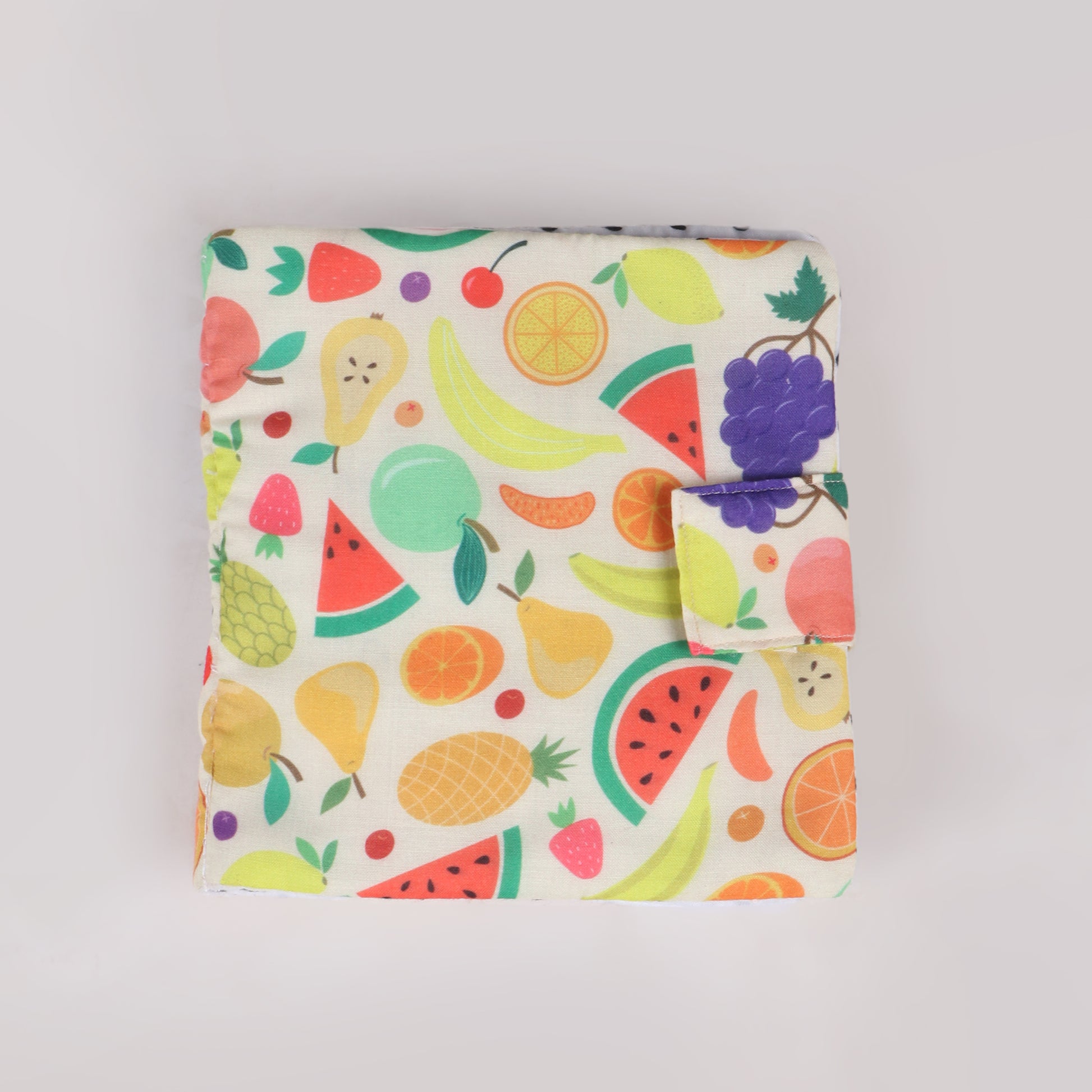 Fruit-themed busy book with fruit printed fabric and has interactive elements, helping toddlers learn about colors, shapes and fruits