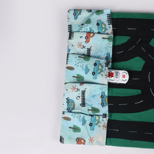 Close up of mint green color, car printed portable fabric car playmat with roads, pockets for car parking, designed for interactive play on the go