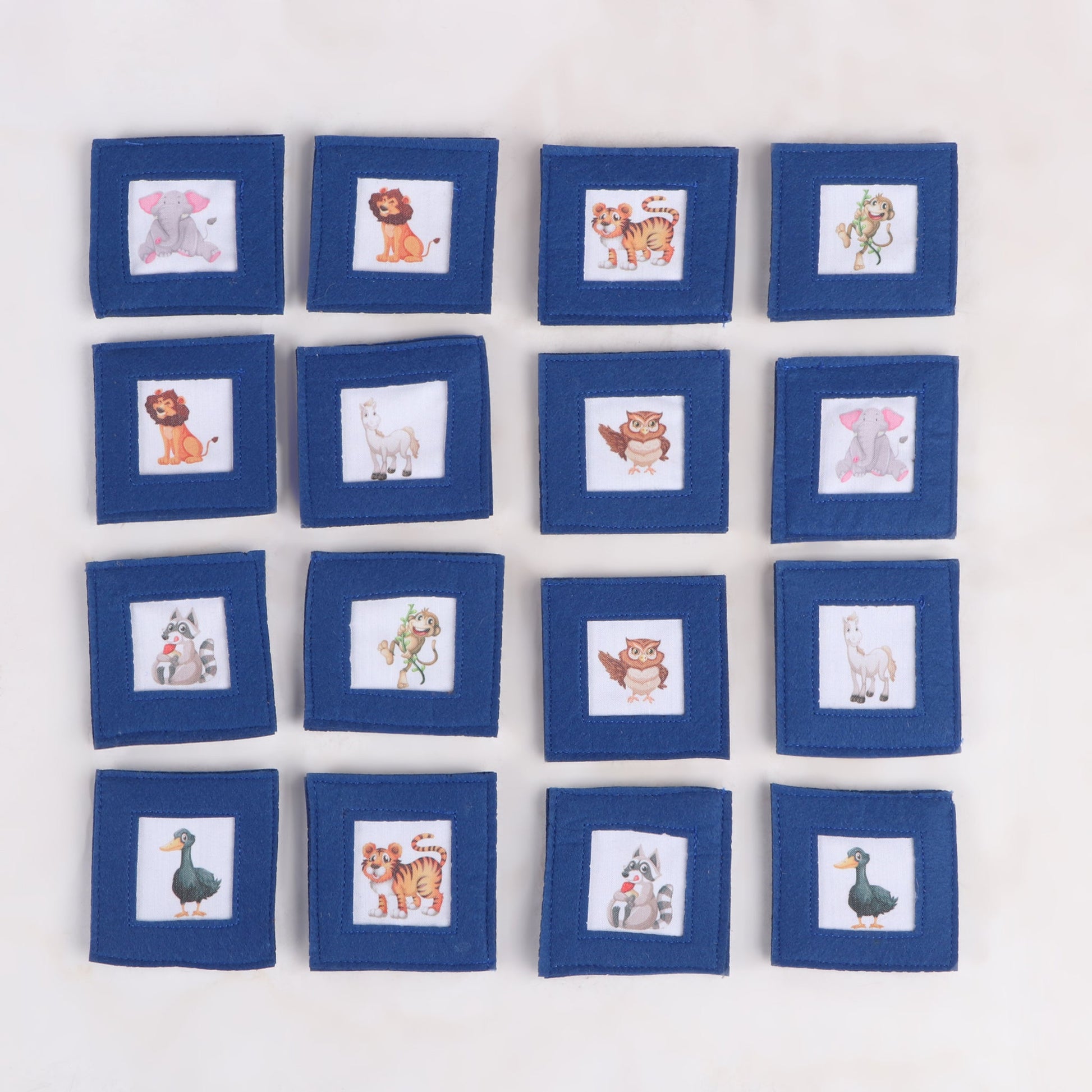 8 sets of handcrafted fabric memory matching game with various animal print, showing all of its flipped side designed for cognitive development and fun learning