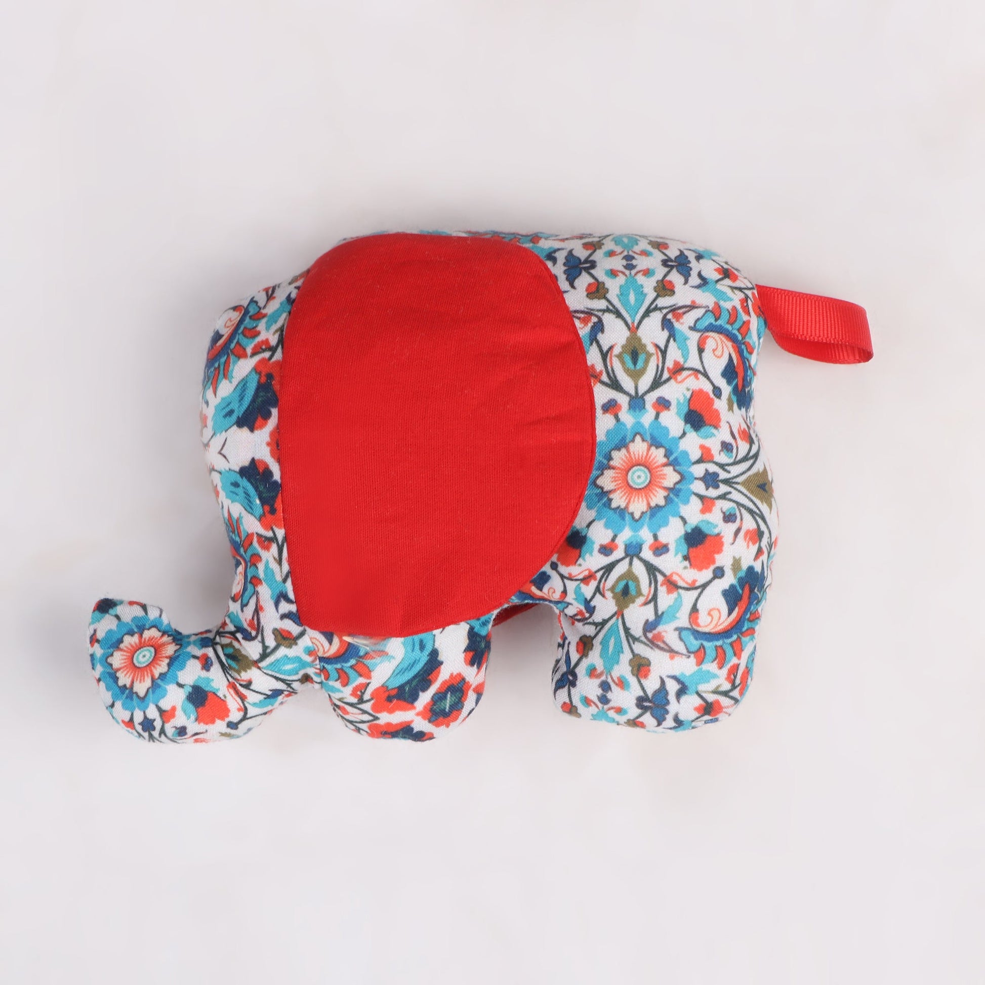Elephant-shaped sensory taggie toy with big red colored ears for tactile exploration and comfort.