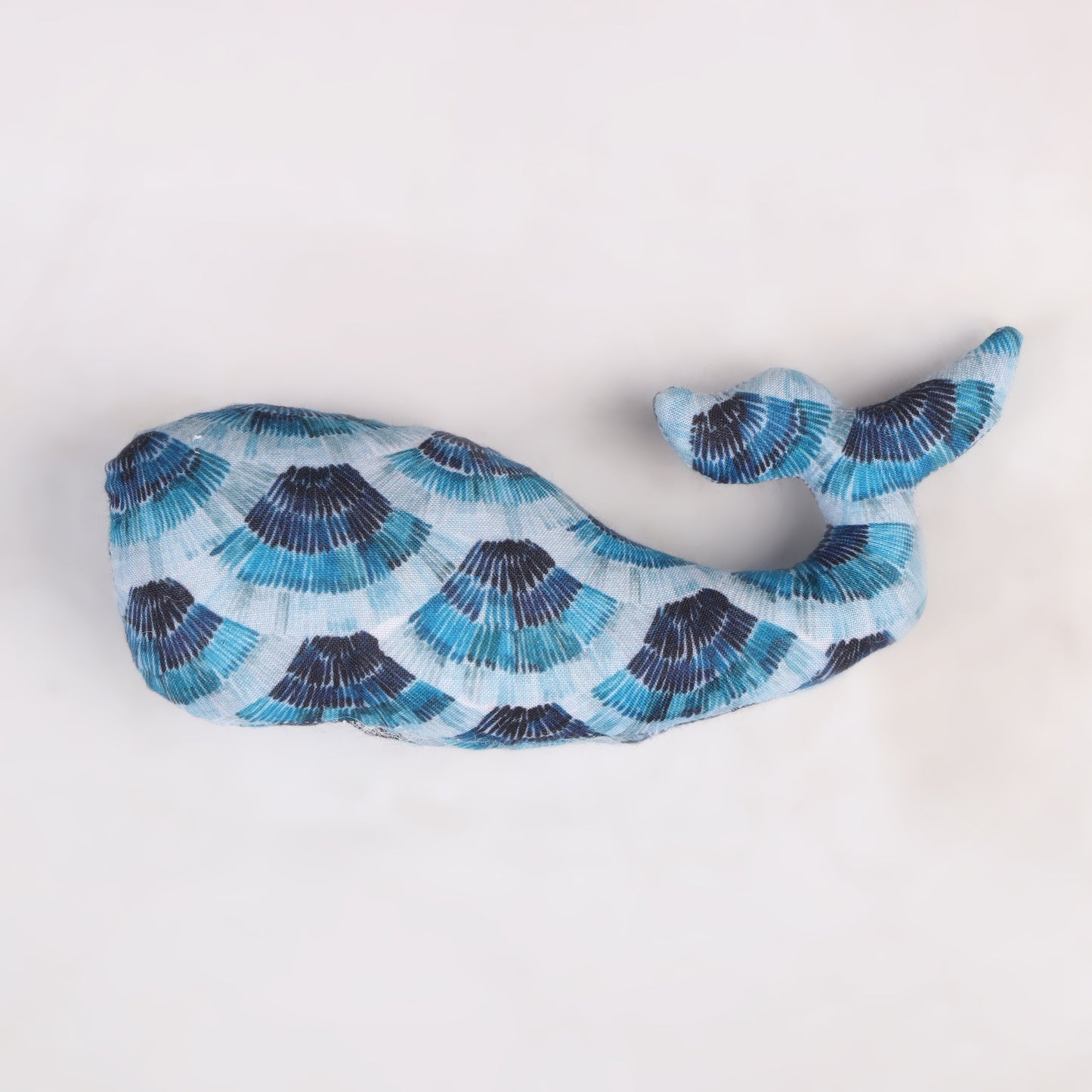 Shark-shaped sensory taggie toy with blue colored fabric for tactile exploration and comfort