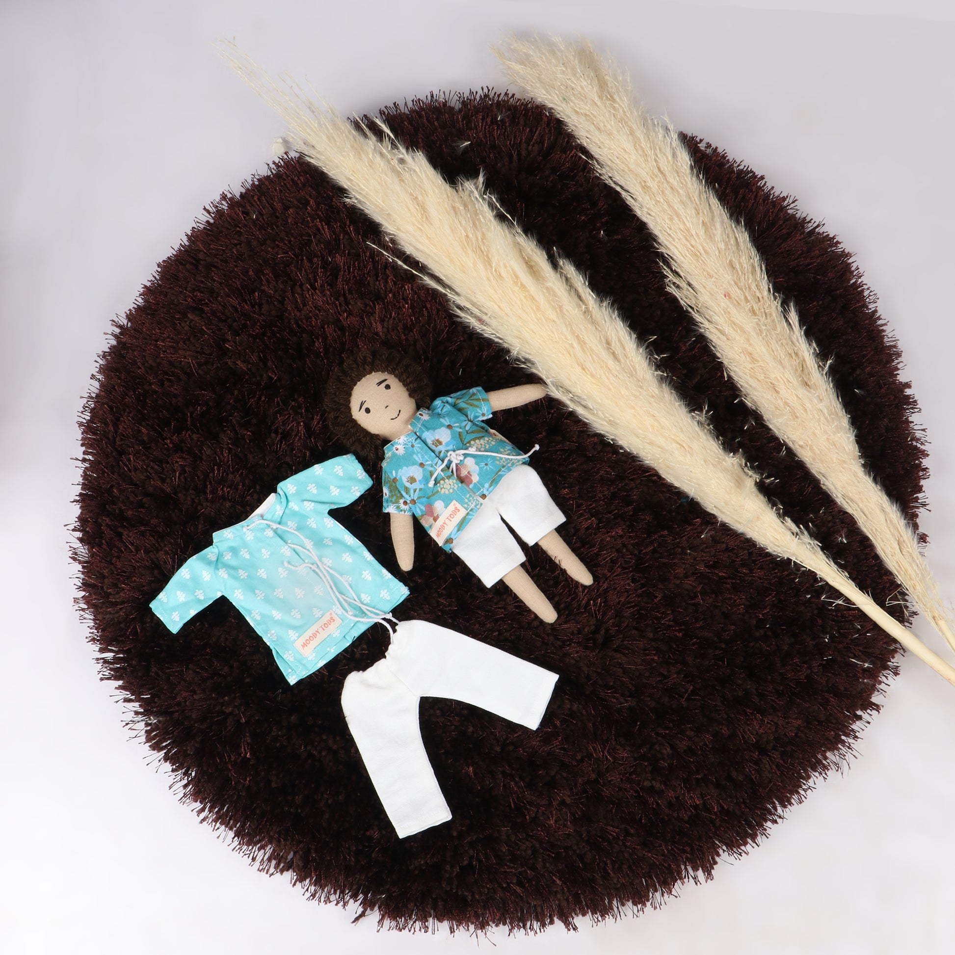 9 inch handmade fabric boy rag doll in floral shirt and white shorts with interchangeable dress made with soft, child-friendly material, designed for comfort and imaginative play