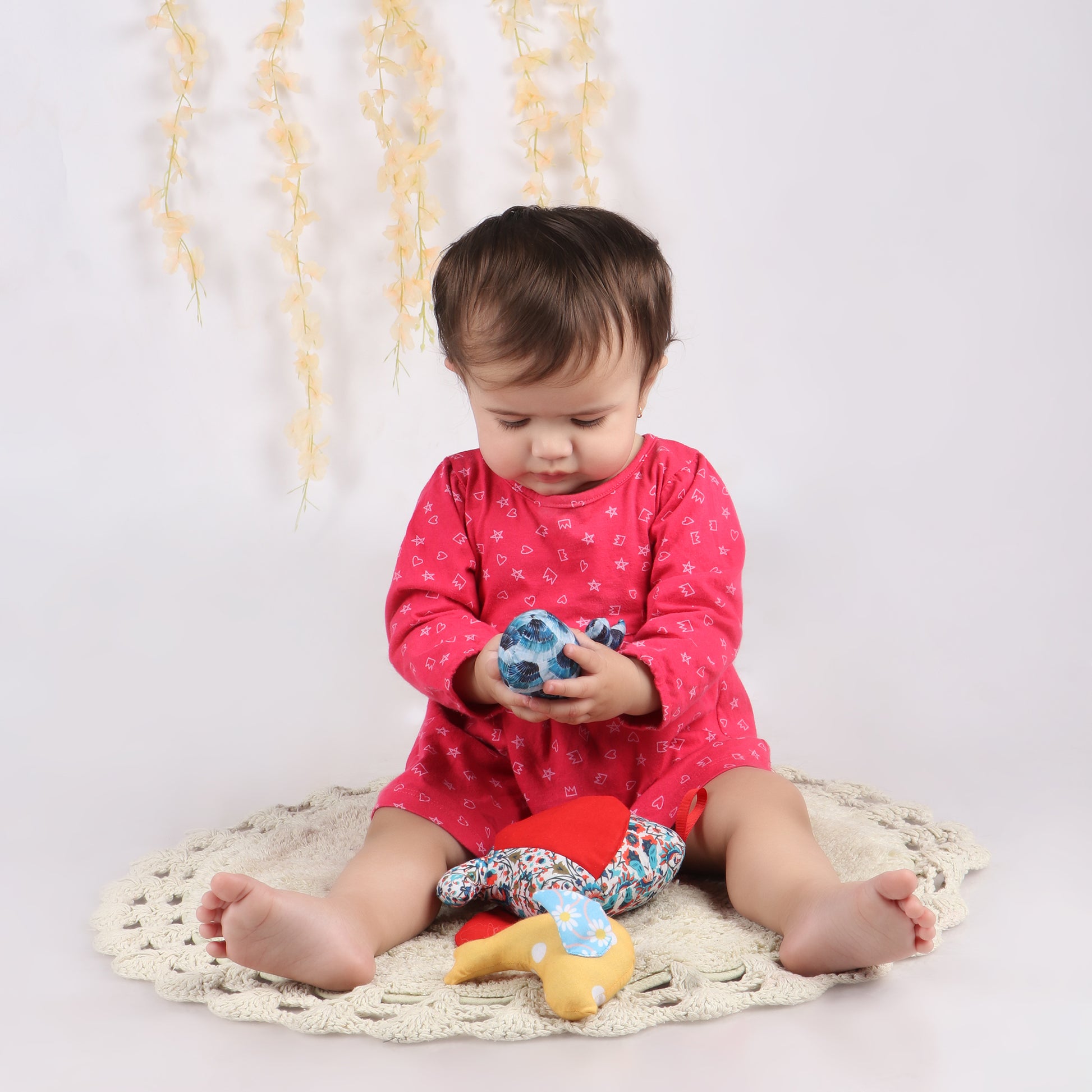 Toddler holding Shark-shaped sensory taggie toy demonstrating its child-friendly size for tactile exploration and comfort