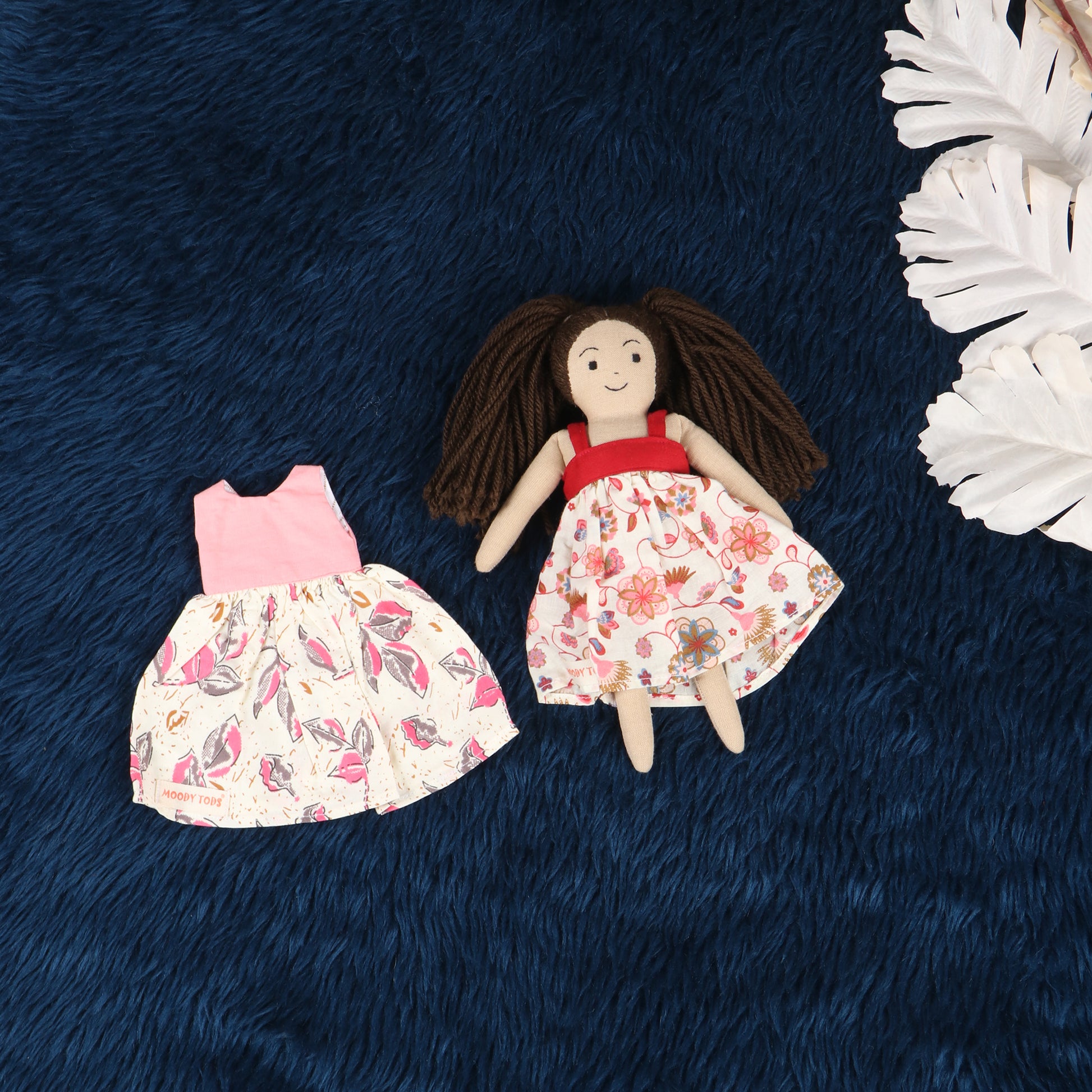 Handmade fabric rag doll with interchangeable frock, made from, soft, sensory-friendly material, designed for comfort and imaginative play.